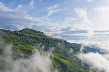 Aerial view of sunrise above fluffy sea fog misty clouds with mountain hill from Phu Tub Berk, Khao Kho, Phetchabun with sunlight. Abstract nature landscape background in morning time.