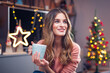 © Gabi Moisa - Beautiful young smiling woman at Christmas drinking a cup of tea