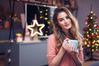 © Gabi Moisa - Beautiful young smiling woman at Christmas drinking a cup of tea