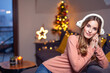 © Gabi Moisa - Beautiful young smiling woman at Christmas listening to music