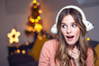 © Gabi Moisa - Beautiful young smiling woman at Christmas listening to music