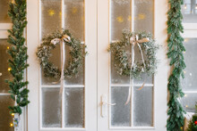 White Wooden Door With A Christmas Tree Wreath Hanging