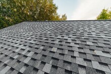 New Renovated Roof Covered With Shingles Flat Polymeric Roof-tiles