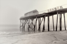 Chairs On A Wooden Pier On A Foggy Day In Long Exposure.