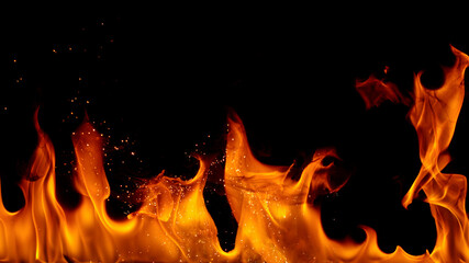 Wall Mural - fire flames with sparks on a black background, close-up