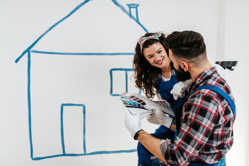 Wall Mural - Happy parents preparing room for their child.