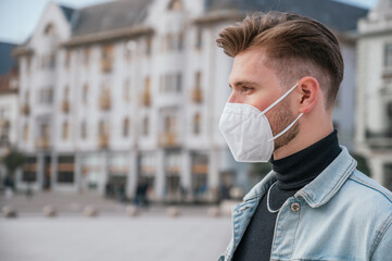 Young handsome man with mask outdoors