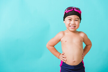 summer vacation concept, closeup portrait asian happy cute little child boy wearing goggles and swim