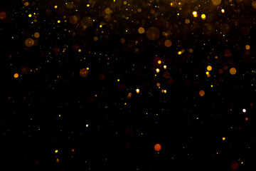 Wall Mural - Gold bokeh of lights on black background