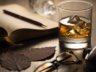 Wall Mural - Backlit glass of whisky on the rocks