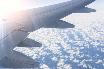 Wall Mural - view through the window of the plane, view of the engine. airplane flying over the sea of clouds. tr
