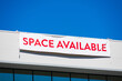 Space Available large banner sign on vacant commercial office building facade advertising the real estate, property, office for sale, rent or lease.