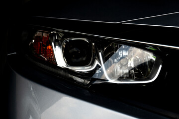 Wall Mural - Abstract and close up of dark tone luxury car headlights. for transtport technology background.