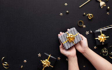 Wall Mural - merry christmas and new year celebration concepts with person hand holding gift box and ornament in 