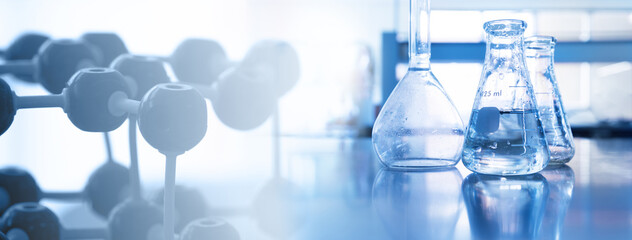 Wall Mural - water in flask with molecular structure science equipment in laboratory banner blue background