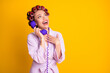 Portrait of nice glamorous cheerful woman wearing curlers talking on phone friend isolated bright yellow color background