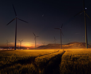 Beautiful sunset field with wind mill generators. big city in background