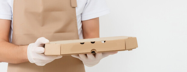 Canvas Print - Photo of happy man from delivery service in t-shirt giving food order and holding pizza boxes isolated over white background