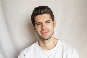 Portrait of a young handsome man with a serious look and perfect beard 