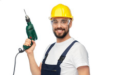 Profession, Construction And Building - Happy Smiling Male Worker Or Builder In Helmet And Goggles With Drill Over White Background