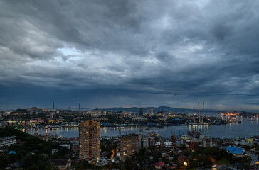 Fototapete - Cityscape with dark moody sky.