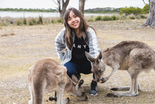 Beautiful Young Chinese Female Feeding Kangaroos