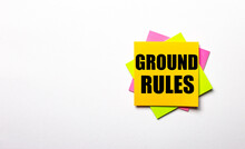 On A Light Background - Bright Multicolored Stickers With The Text GROUND RULES. Copy Space