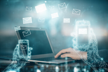 Envelop hologram drawing with businessman working on computer on background. Electronic mail concept. Double exposure.