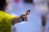 Shallow depth of field with handball referee hand holding a whistle
