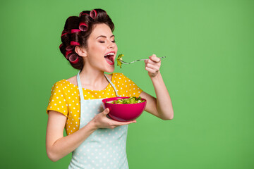 Sticker - Turned photo of positive vintage girl enjoy veggie supper eat fork salad bowl wear yellow dotted dress skirt hair rollers isolated over green color background