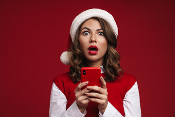 Wall Mural - Shocked young woman in christmas santa hat