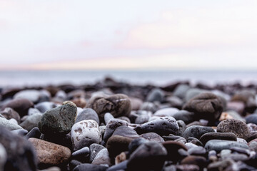 Close up blurred sea stones on the coast