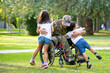© Mangostar - Happy disabled military man in wheelchair returning home and hugging kids. Veteran of war or family reunion concept