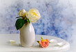 White roses in white vase