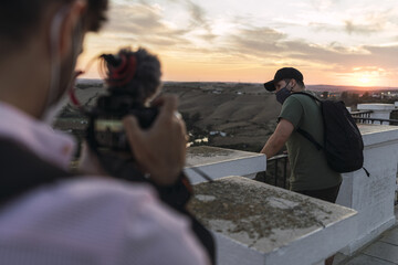 Young male taking a video of his friend talking in a town in Andalusia, Spain