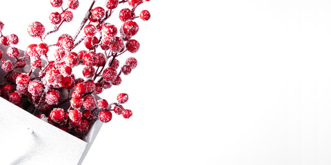 Wall Mural - Christmas minimal holiday composition. Festive paper bag with Xmas red berries decorations on white background. Christmas, New Year, winter concept. Flat lay, top view, copy space