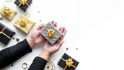 Wall Mural - merry christmas and new year celebration concepts with person hand holding gift box and ornament in 