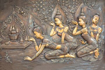 Buddha metal copper carving on temple wall in Thailand.Buddha sculpture tell the story about the Buddha's history.