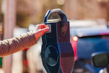 Woman Pay On Street Parking Meter Pole In The USA City