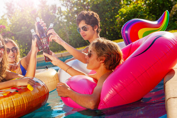 Wall Mural - Group of children party drinking soda and play in swim pool together outside