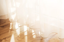 Transparent White Curtain Tulle From An Open Window. Sunny Day, The Sun's Rays Sunlight Penetrate The Room.