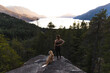 © Christian Tisdale/Stocksy - A fit female runner overlooking the BC Coast with her dog