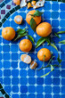 © Pietro Karras/Stocksy - Tangerines on blue checkered table