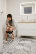 © Susana Ram√≠rez/Stocksy - Woman on the toilet looking at her mobile phone