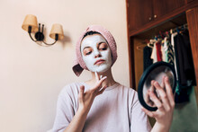 Young Woman Applying Clay Mask