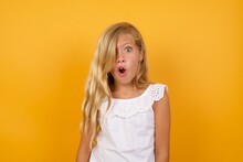 Beautiful Caucasian Young Girl Standing Against Yellow Background Expressing Disgust, Unwillingness, Disregard Having Tensive Look Frowning Face, Looking Indignant With Something.