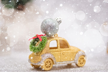 Wall Mural - Christmas card with decorated gold car Christmas ball on a light background. Winter festive concept