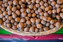 Top View Of A Basket Of Unshelled Walnuts