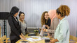 © Ron - Business women from different ethnic races and cultures working together in an office for business development or plan