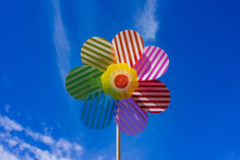 Colorful Flower Wind Spinner Toy On A Blue Sky Background